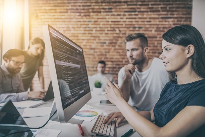 Salesforce developers working at a computer